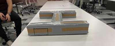 A picture containing text, indoor, person, worktable

Description automatically generated