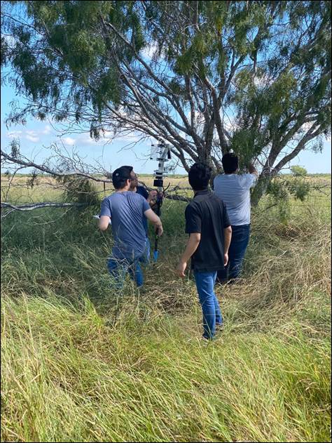 A group of people walking through a grassy field

Description automatically generated with low confidence